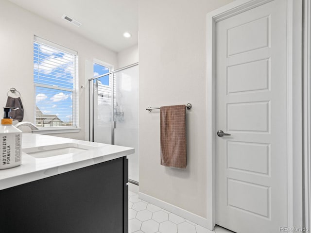 bathroom with recessed lighting, baseboards, visible vents, a shower stall, and vanity