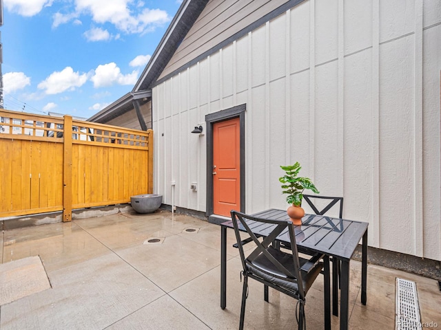 view of patio featuring visible vents, fence, and outdoor dining space