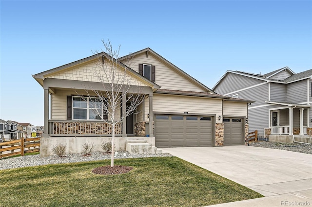 235 Yellowtail St, Bennett, CO 80102 - view of front of property featuring a porch, an attached garage, fence, concrete driveway, and a front lawn