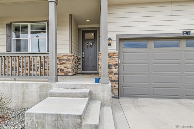235 Yellowtail St, Bennett, CO 80102 - entrance to property with a garage, stone siding, and covered porch