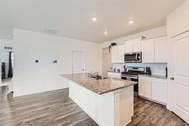 235 Yellowtail St, Bennett, CO 80102 - kitchen with stainless steel appliances, visible vents, a sink, and decorative backsplash