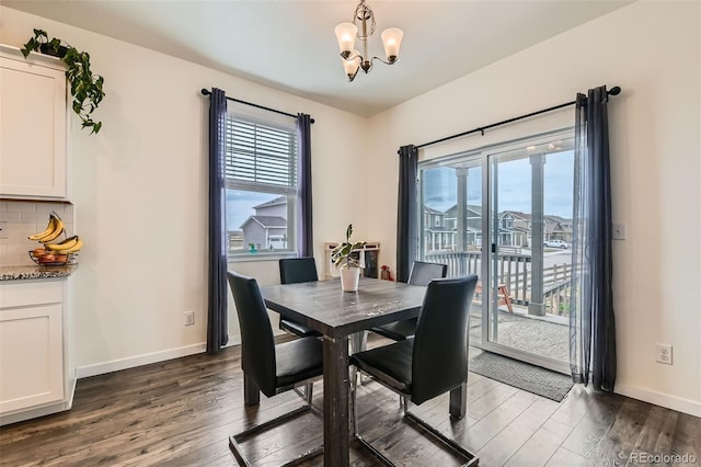235 Yellowtail St, Bennett, CO 80102 - dining space with a chandelier, baseboards, and dark wood-style floors
