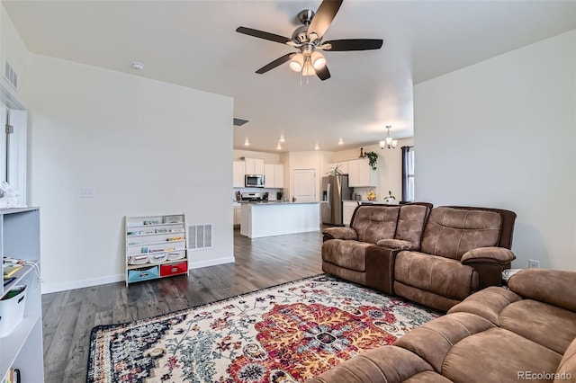 235 Yellowtail St, Bennett, CO 80102 - living area featuring dark wood finished floors, baseboards, a ceiling fan, and visible vents