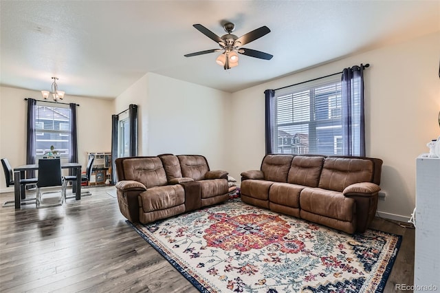 235 Yellowtail St, Bennett, CO 80102 - living room with baseboards, wood finished floors, and ceiling fan with notable chandelier