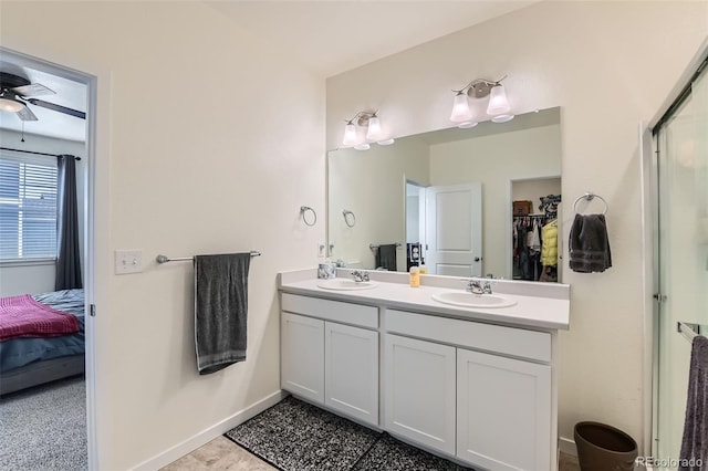 235 Yellowtail St, Bennett, CO 80102 - ensuite bathroom featuring a sink, a walk in closet, a ceiling fan, and double vanity