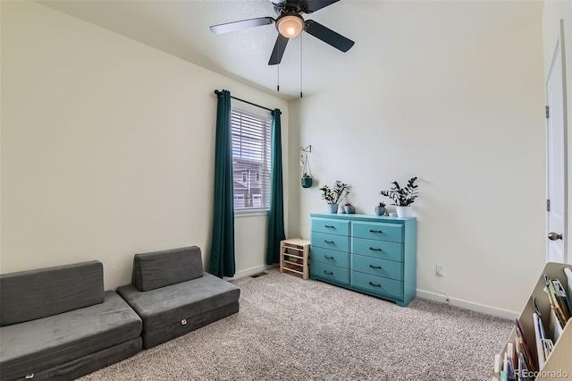 235 Yellowtail St, Bennett, CO 80102 - living area featuring light colored carpet, baseboards, and a ceiling fan