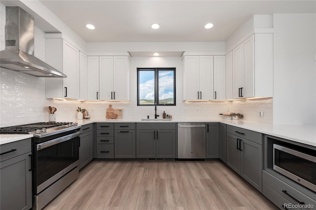 2101 Lupine Ln, Tabernash, CO 80478 - kitchen featuring appliances with stainless steel finishes, wall chimney exhaust hood, gray cabinets, a sink, and recessed lighting