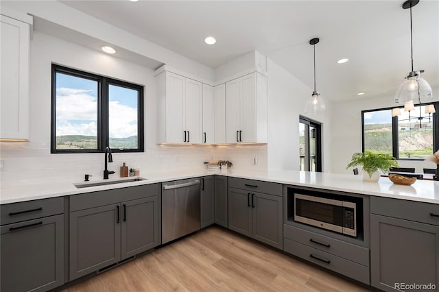 2101 Lupine Ln, Tabernash, CO 80478 - kitchen with stainless steel appliances, a sink, gray cabinetry, light wood-type flooring, and recessed lighting