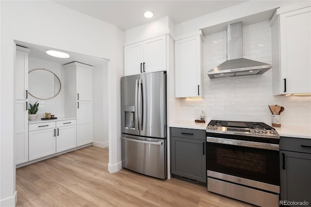 2101 Lupine Ln, Tabernash, CO 80478 - kitchen with stainless steel appliances, wall chimney range hood, backsplash, light countertops, and gray cabinetry