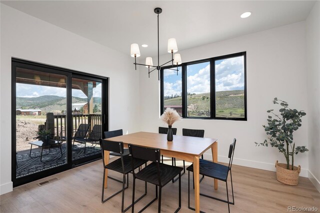 2101 Lupine Ln, Tabernash, CO 80478 - dining area featuring healthy amount of natural light, light wood-type flooring, a chandelier, and recessed lighting