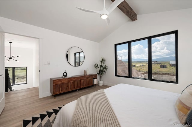 2101 Lupine Ln, Tabernash, CO 80478 - bedroom featuring light wood-style floors, a chandelier, baseboards, a mountain view, and a ceiling fan
