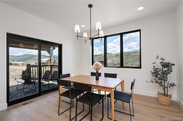 2101 Lupine Ln, Tabernash, CO 80478 - dining room with healthy amount of natural light, light wood-style floors, a chandelier, and recessed lighting