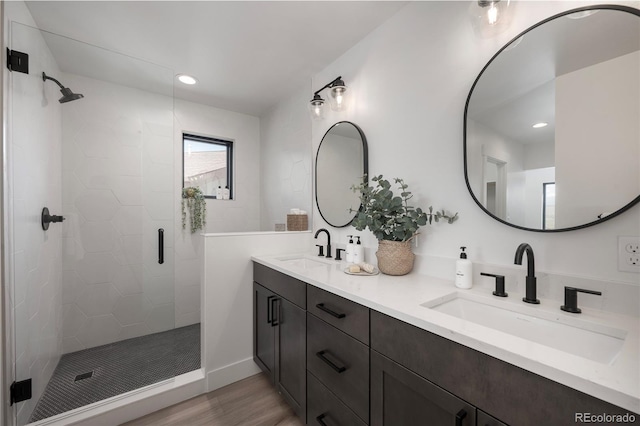 2101 Lupine Ln, Tabernash, CO 80478 - bathroom featuring wood finished floors, a shower stall, double vanity, and recessed lighting