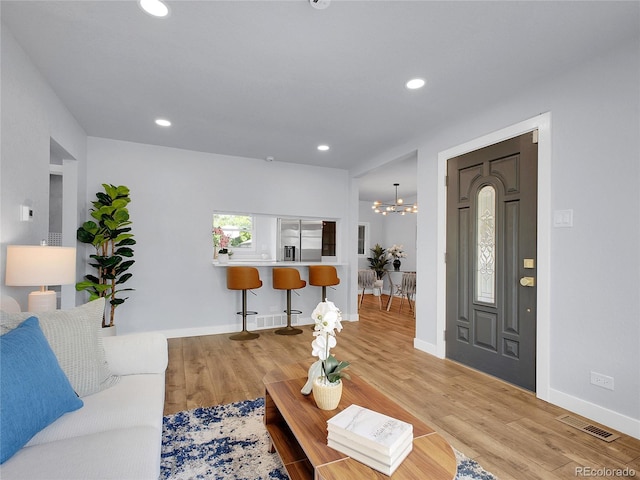 5152 Bryant St, Denver, CO 80221 - living area featuring a chandelier, wood finished floors, baseboards, and recessed lighting