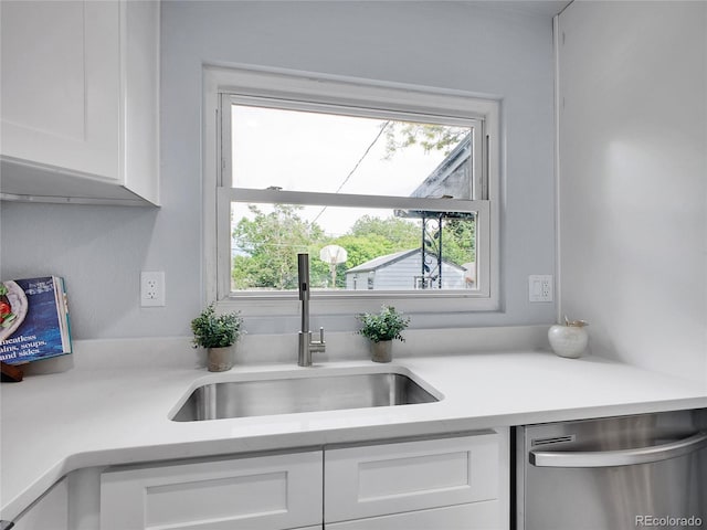 5152 Bryant St, Denver, CO 80221 - kitchen featuring stainless steel dishwasher, a sink, white cabinets, and healthy amount of natural light