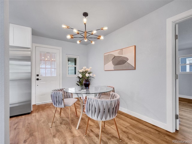 5152 Bryant St, Denver, CO 80221 - dining space with light wood-type flooring, baseboards, and a chandelier