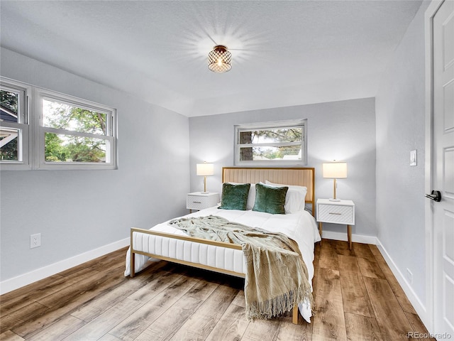 5152 Bryant St, Denver, CO 80221 - bedroom with wood finished floors, multiple windows, and baseboards