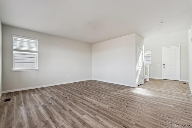 1397 Brookfield Pl, Erie, CO 80026 - unfurnished living room with baseboards, visible vents, plenty of natural light, and wood finished floors