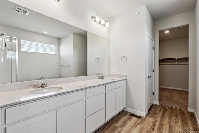 1397 Brookfield Pl, Erie, CO 80026 - full bath featuring visible vents, a sink, wood finished floors, and a shower stall