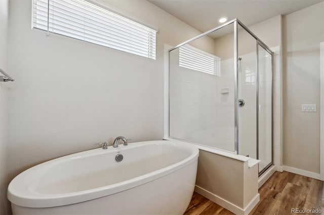 1397 Brookfield Pl, Erie, CO 80026 - full bathroom with a freestanding tub, baseboards, a stall shower, and wood finished floors