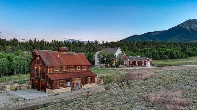 16202 County Road 327, Buena Vista, CO 81211 - rear view of house featuring a forest view, a barn, an outdoor structure, and a mountain view