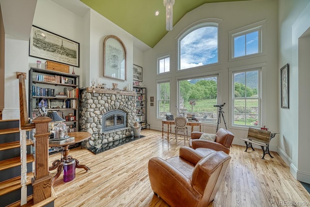 16202 County Road 327, Buena Vista, CO 81211 - living room with wood finished floors, high vaulted ceiling, and a stone fireplace