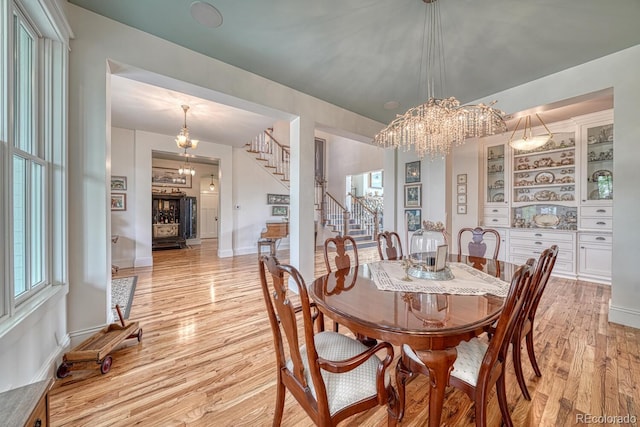 16202 County Road 327, Buena Vista, CO 81211 - dining area with stairway, light wood finished floors, and a chandelier