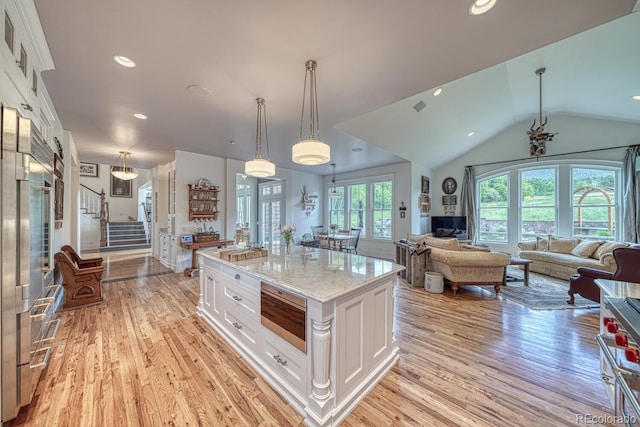 16202 County Road 327, Buena Vista, CO 81211 - kitchen featuring stainless steel microwave, white cabinetry, light wood finished floors, lofted ceiling, and recessed lighting