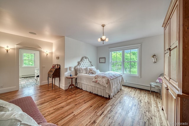 16202 County Road 327, Buena Vista, CO 81211 - bedroom featuring a baseboard heating unit, light wood-style floors, and a chandelier