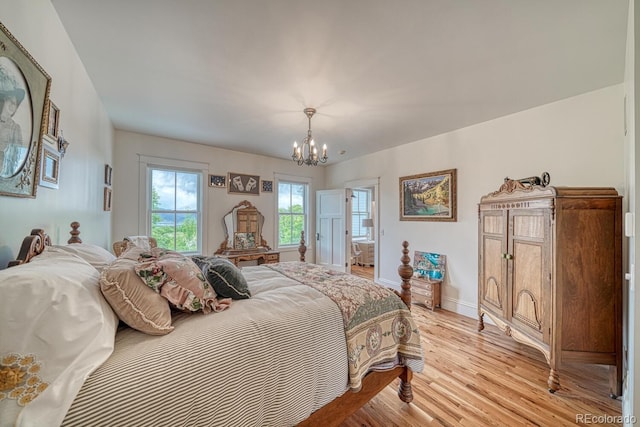 16202 County Road 327, Buena Vista, CO 81211 - bedroom with a chandelier and light wood-style floors