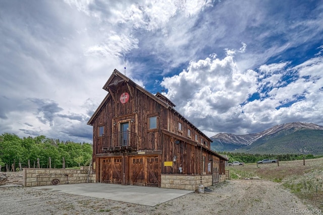 16202 County Road 327, Buena Vista, CO 81211 - view of building exterior with a barn, a mountain view, and a garage
