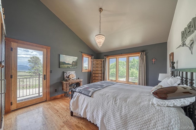 16202 County Road 327, Buena Vista, CO 81211 - bedroom featuring access to exterior, wood finished floors, and high vaulted ceiling