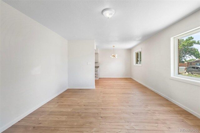 9320 Fir Dr, Thornton, CO 80229 - spare room with a chandelier and light wood finished floors