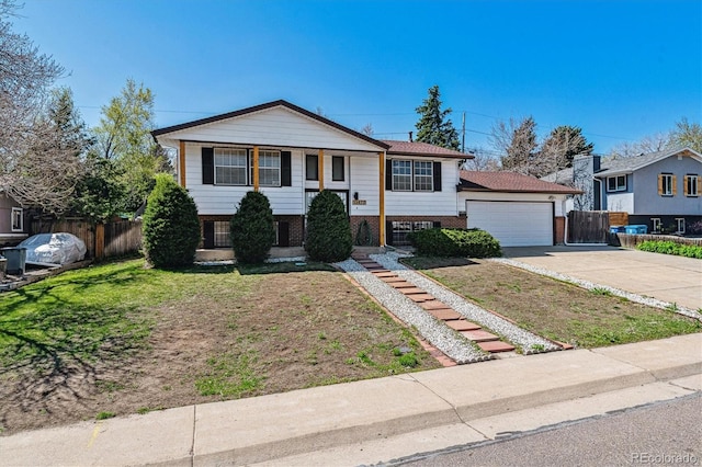 13472 W Dakota Ave, Lakewood, CO 80228 - raised ranch with brick siding, fence, and a front yard