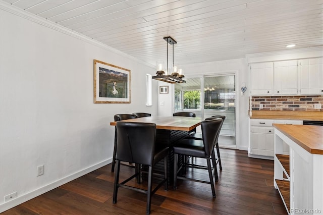 13472 W Dakota Ave, Lakewood, CO 80228 - dining area featuring dark wood-type flooring, ornamental molding, baseboards, and a notable chandelier