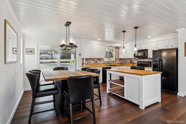 13472 W Dakota Ave, Lakewood, CO 80228 - kitchen with wood counters, white cabinets, backsplash, and black appliances