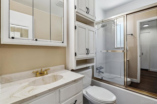 13472 W Dakota Ave, Lakewood, CO 80228 - bathroom featuring vanity, combined bath / shower with glass door, and toilet