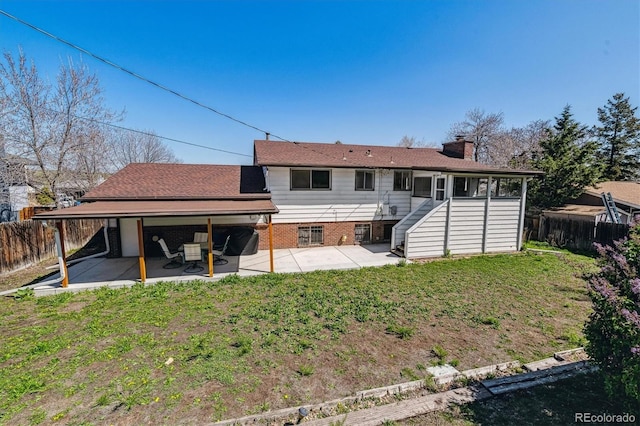 13472 W Dakota Ave, Lakewood, CO 80228 - back of house featuring a lawn, a fenced backyard, a patio area, and a chimney