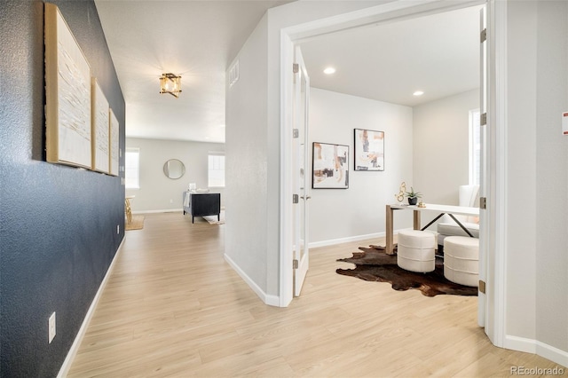 hall featuring visible vents, recessed lighting, light wood-style flooring, and baseboards