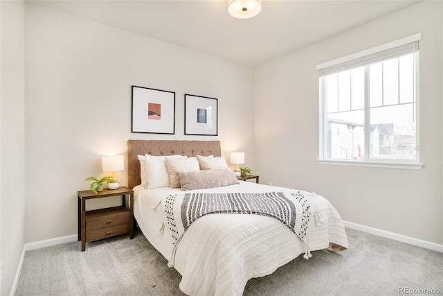 carpeted bedroom featuring baseboards