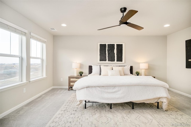 bedroom with light carpet, visible vents, and baseboards