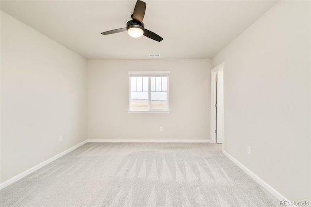 unfurnished room with baseboards, ceiling fan, visible vents, and light colored carpet