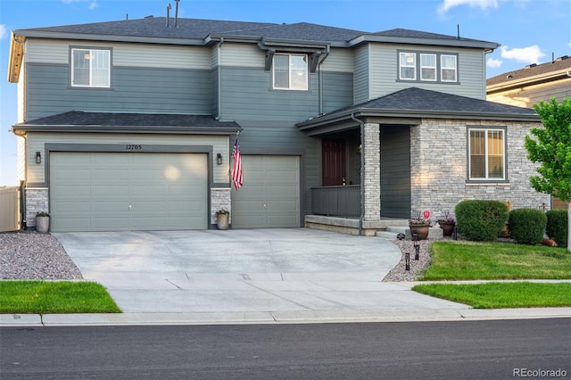 view of front facade featuring driveway, stone siding, roof with shingles, and an attached garage