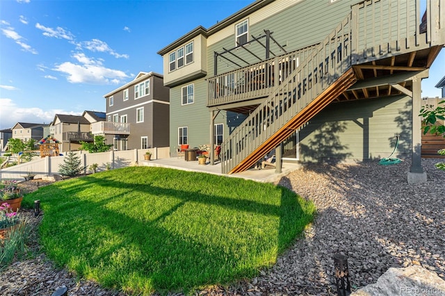 exterior space with a residential view, stairs, fence, a yard, and a patio area