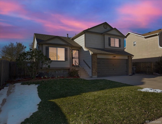 view of front of house with a garage and a yard