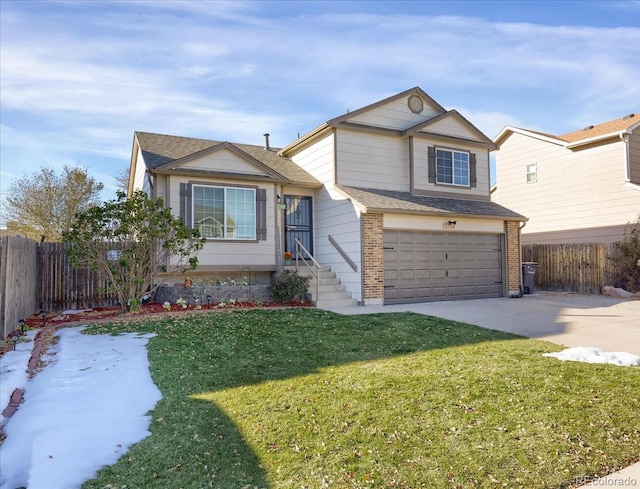 view of front of house with a front yard and a garage