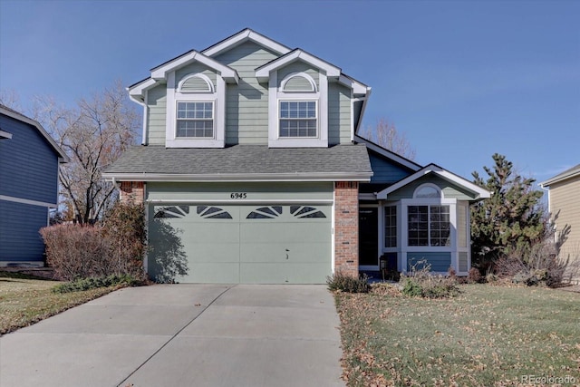 front facade featuring a front yard and a garage