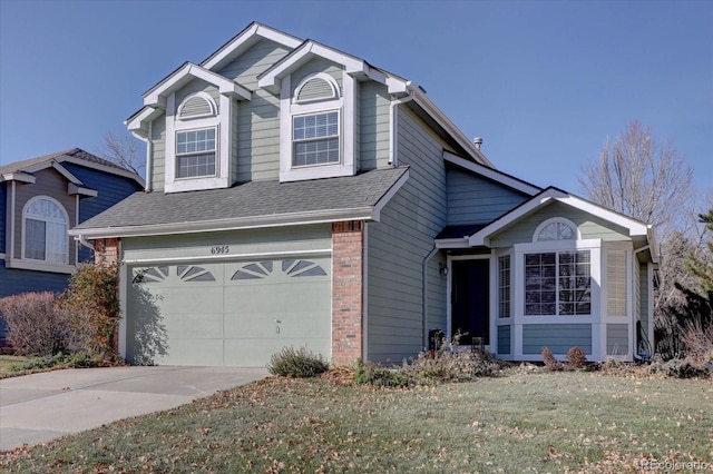 view of front property featuring a garage and a front lawn