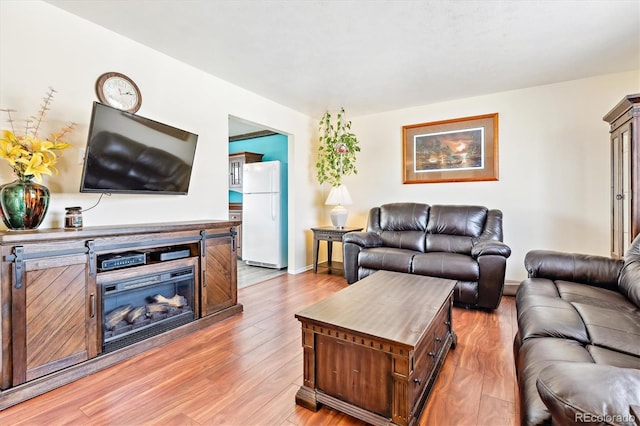 living room with light wood-style flooring and baseboards