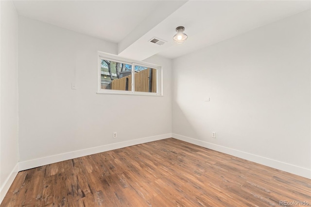 spare room with hardwood / wood-style floors